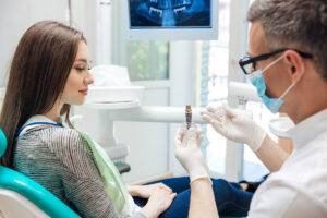 Dentist explaining an implant and bone graft treatment plan