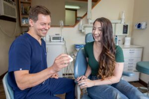 Dr. Shimp discussing dental treatment with a patient